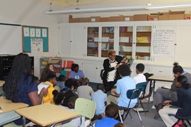 Superintendent Dr. Lora Adams-King reads to 6th grade students during the African American Read-In