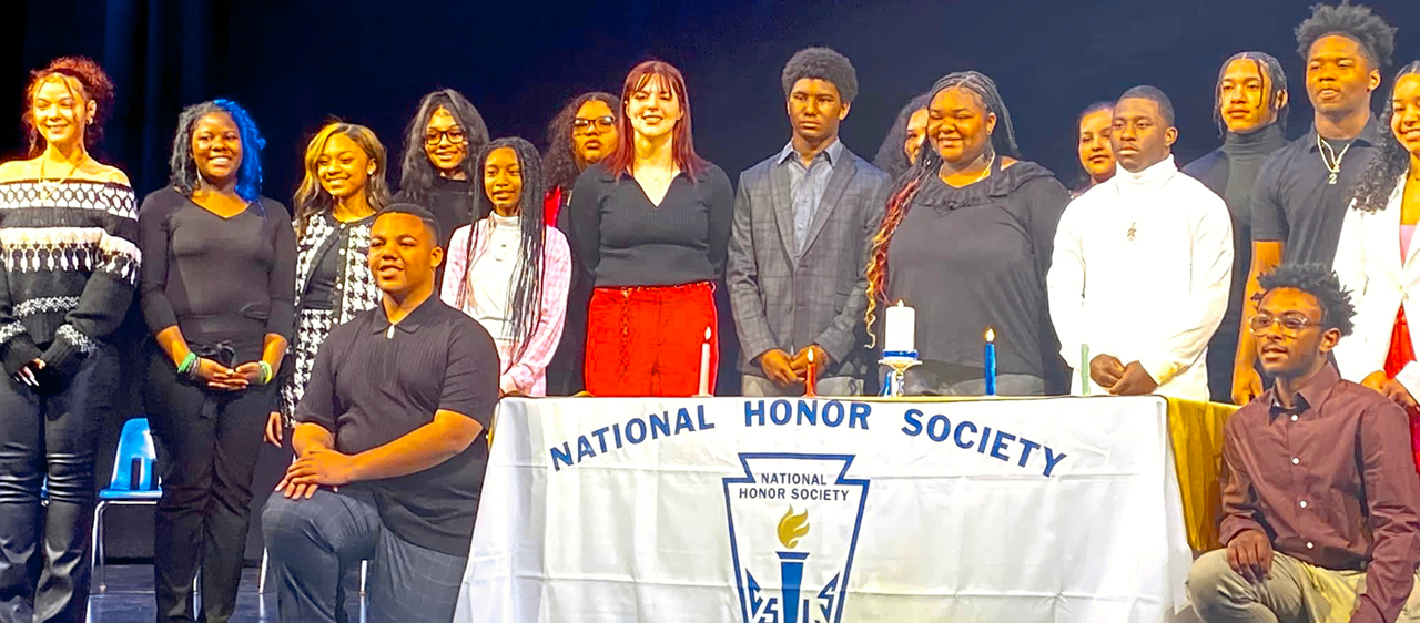 Students on stage at the 2023 National Honor Society induction ceremony