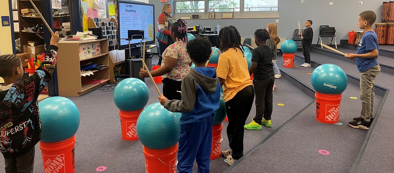 2nd grade students participating in a cardio drumming activity in music class