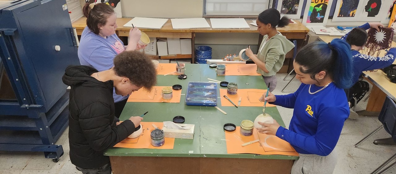 Art students creating bowls for the Community Food Warehouse